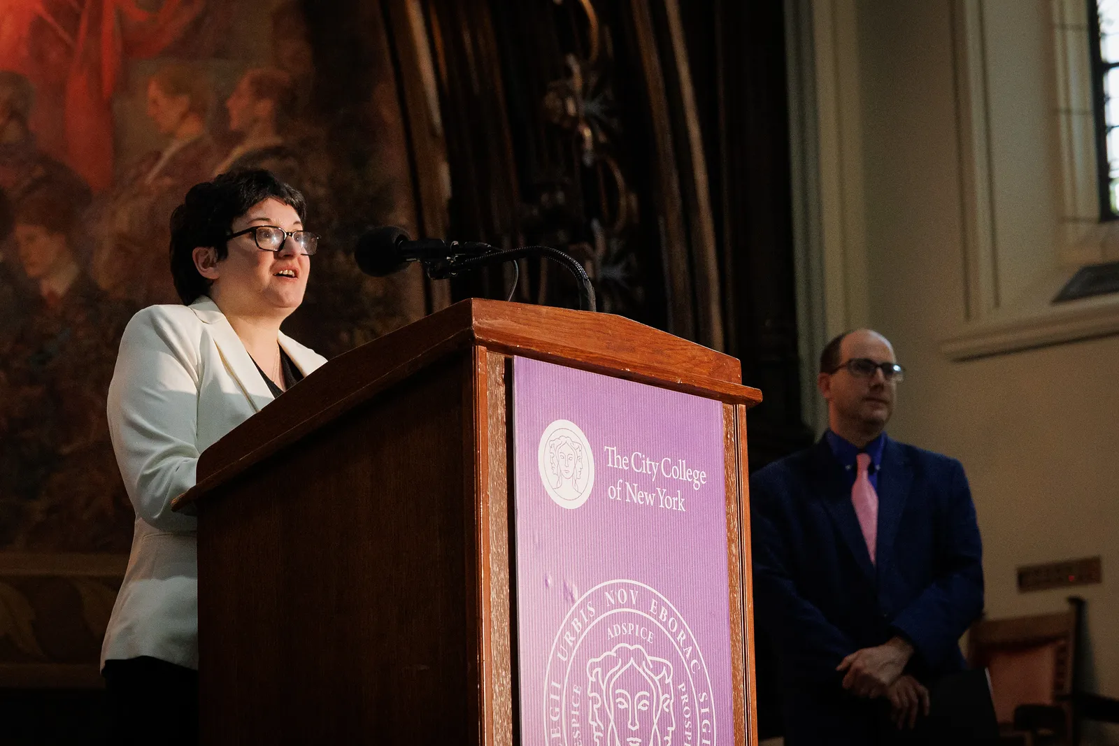Lorenza Favrot speaks at a podium labeled CCNY.