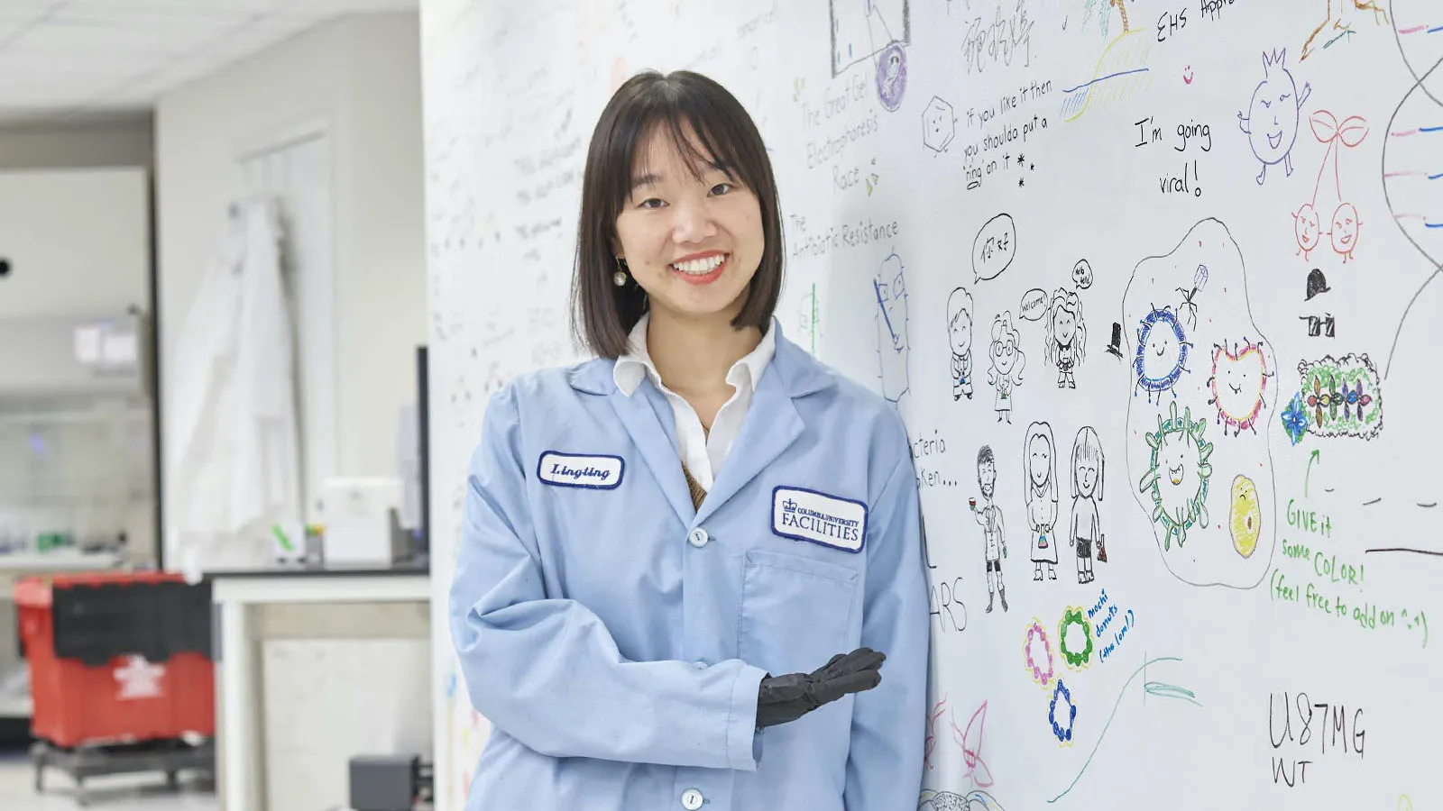Lingting Shi points to formulae on a whiteboard in the Azizi lab.