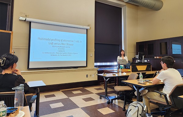 a woman presenting slides in front of an audience