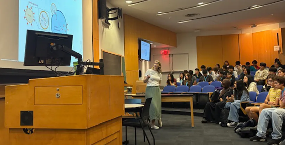 Researcher presenting to SHAPE high school students.