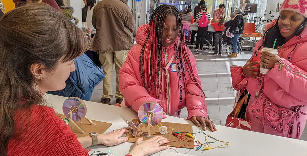 Kids doing a DIY hand crank generator (Electronics Day). Photo credit: STEM Starters.
