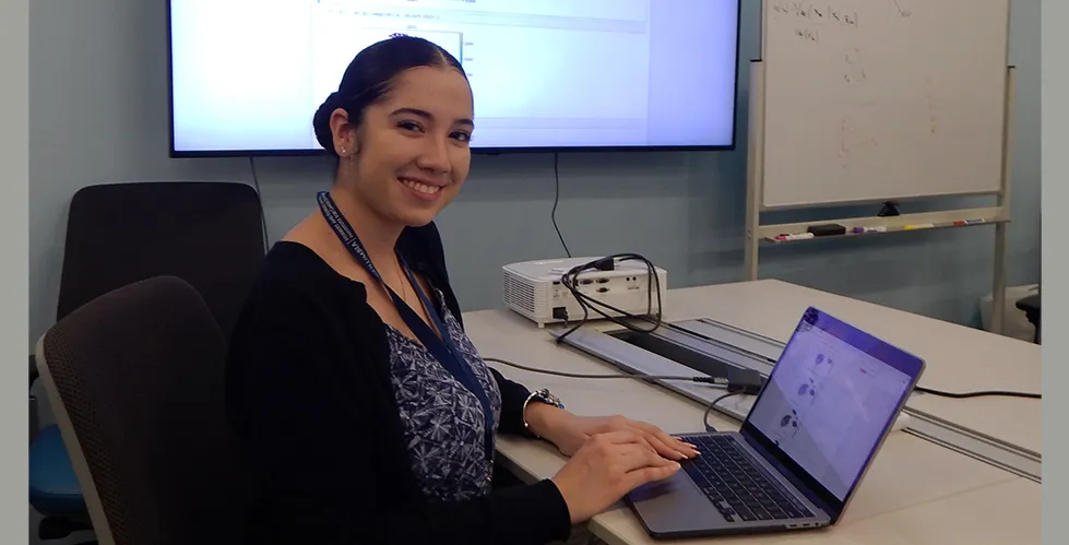Anabel Ojeda working on a laptop