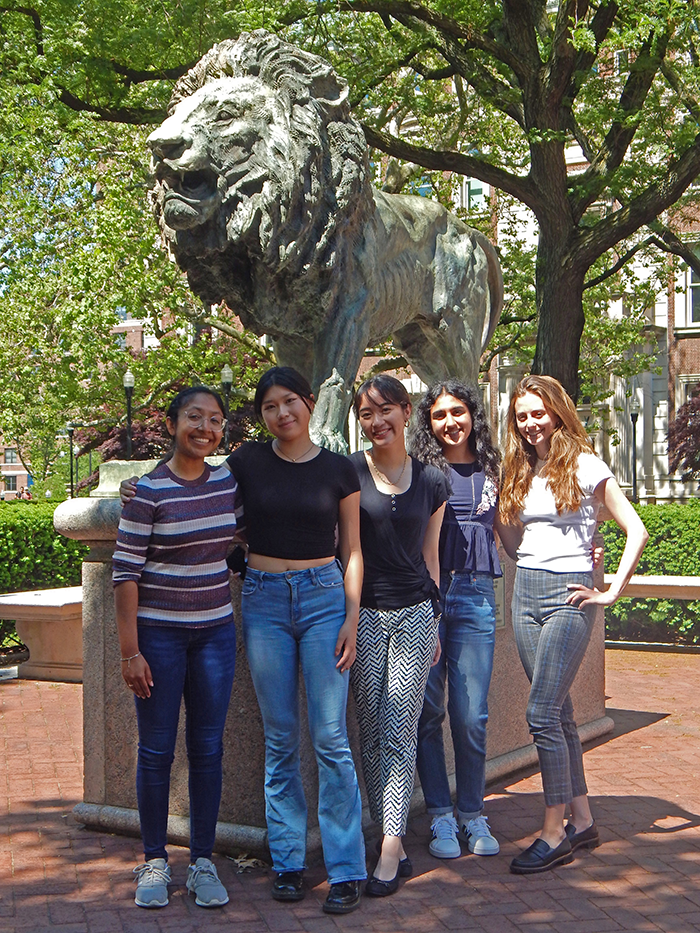 Photo of 5 women in front of a lion statue