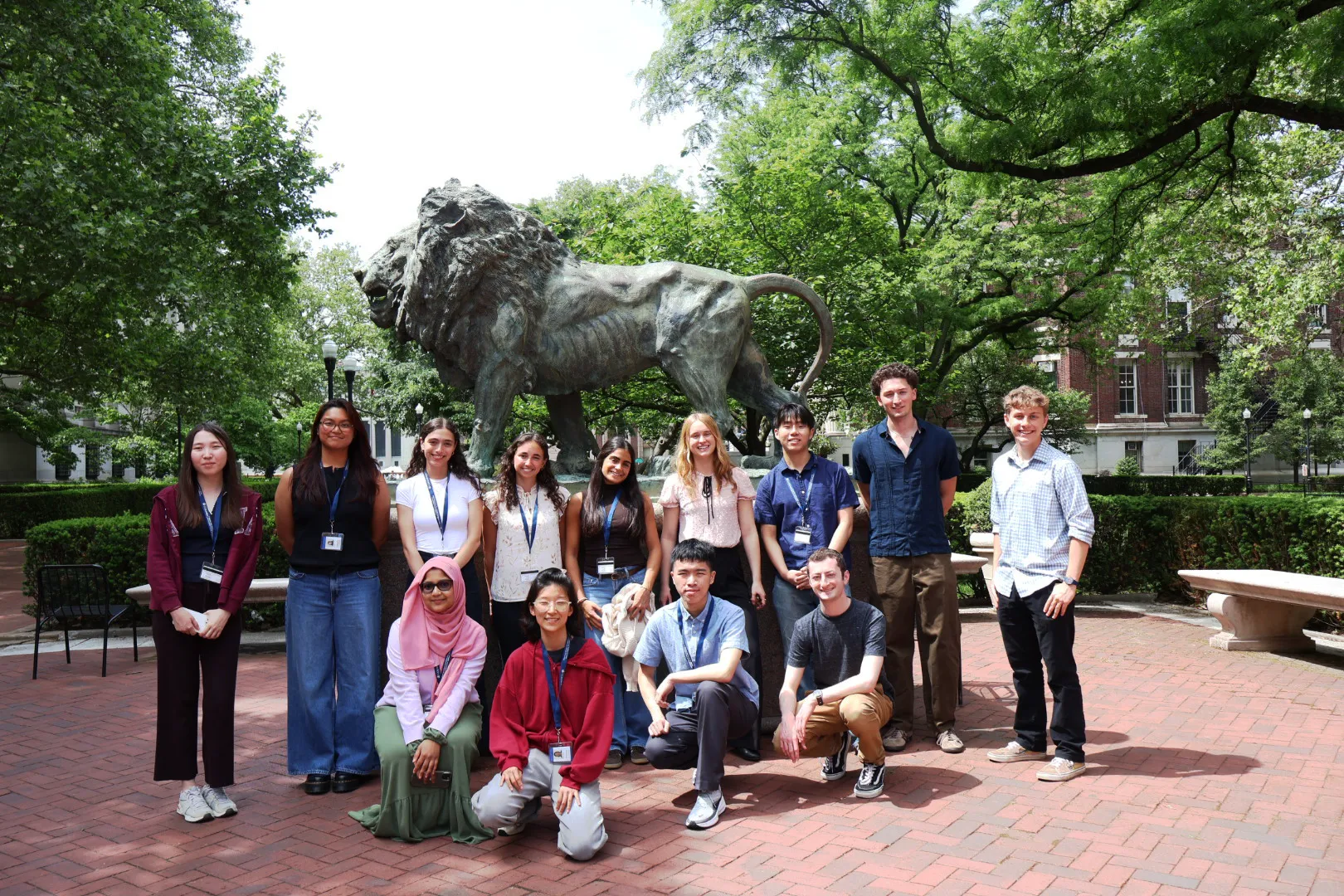 2026 SRP interns stand in front of lion statue on Columbia University campus.