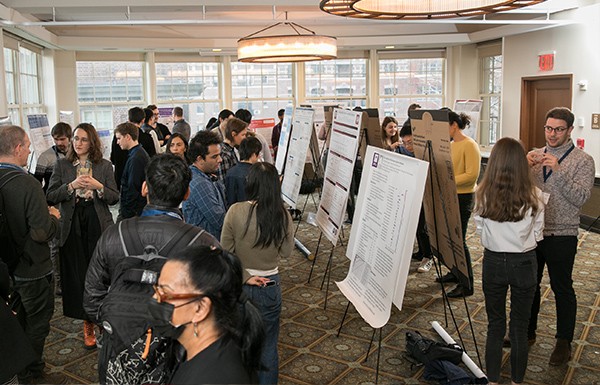 group of people discussing at a poster session