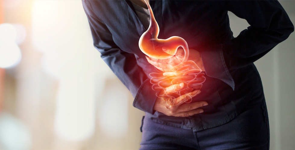The Molecular Origins of Two Types of Cancer Are More Closely Associated Than We Knew (photo credit: Shutterstock) someone holding their stomach that is painful